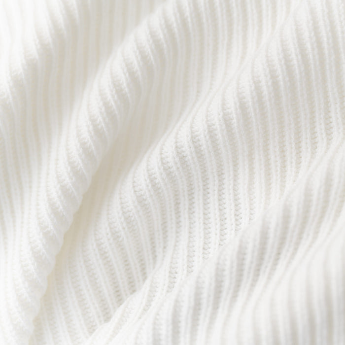 Close up of chunky knit fabric: A warm white