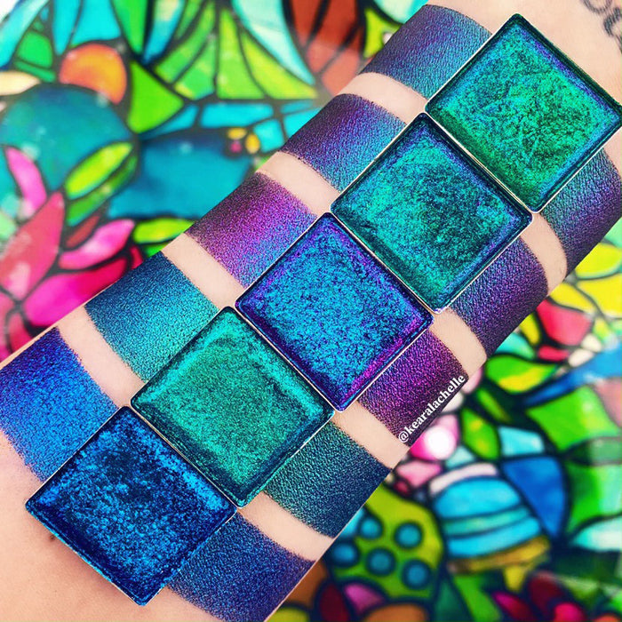 Top angled Crown Glass Jewelled Multichrome Eyeshadow overtop arm swatches on fair skin tone compared to Oculus, Anneal, Castle, Lunette