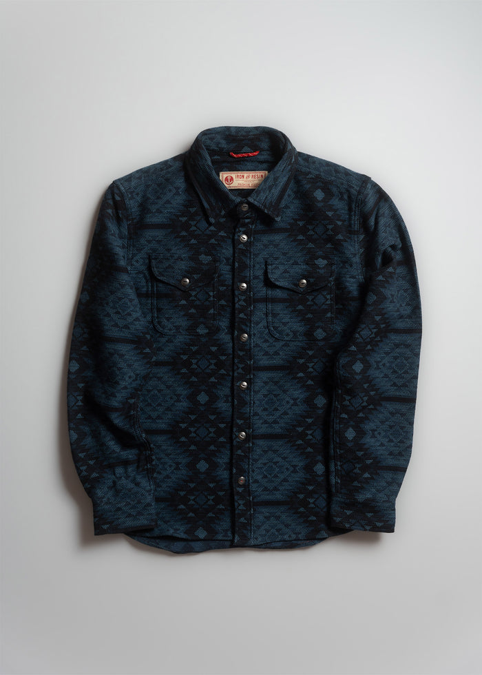 Blue patterned button-up shirt with two chest pockets, displayed on a plain background. Iron & Resin label inside the collar.