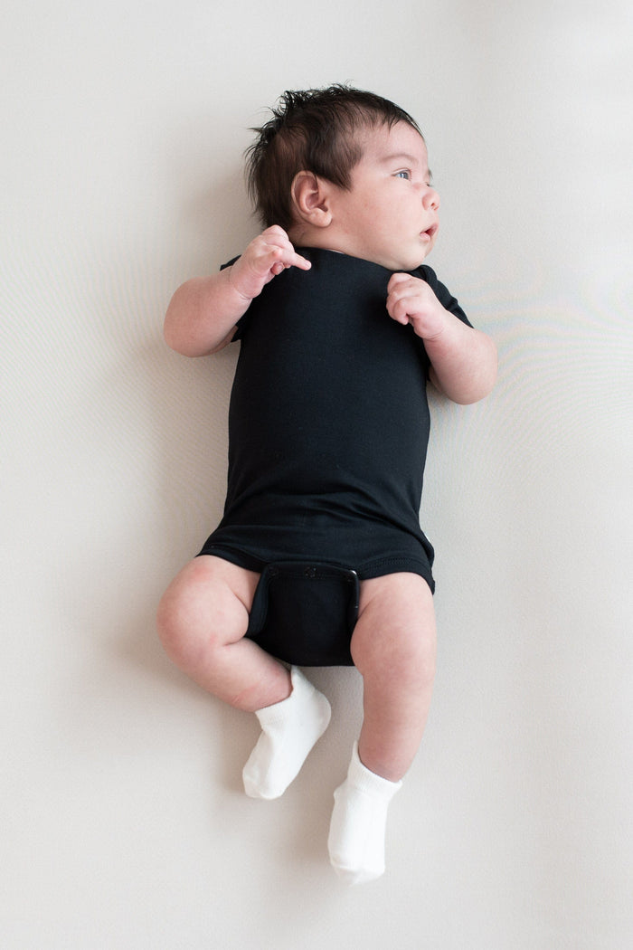 Infant wearing Kyte Baby Ankle Socks in Neutral white