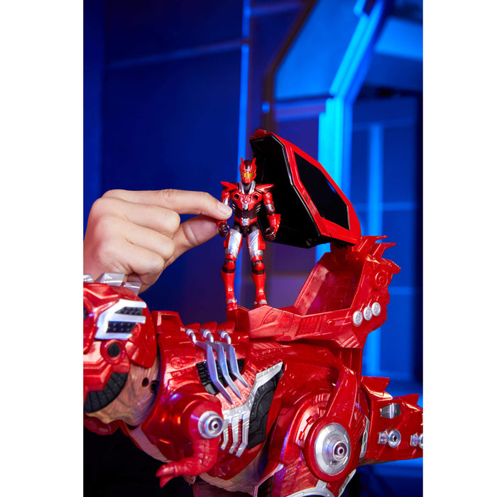Red toy dino with a figure on top, set against a blue background