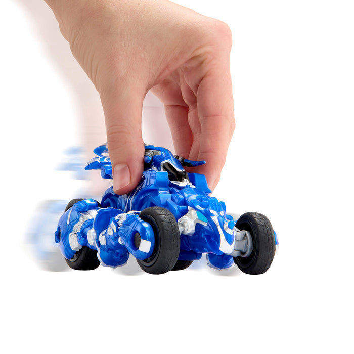 Toy car with spinning wheels being held by a hand on a white background