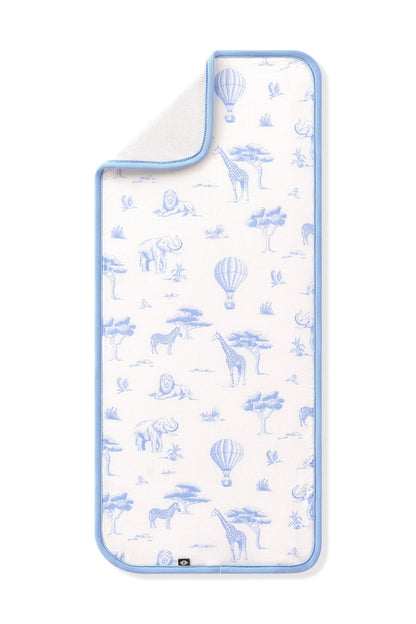 The Burp Cloth in Toile Safari shown laid flat with the corner folded down showing the absorbent bamboo terry backing