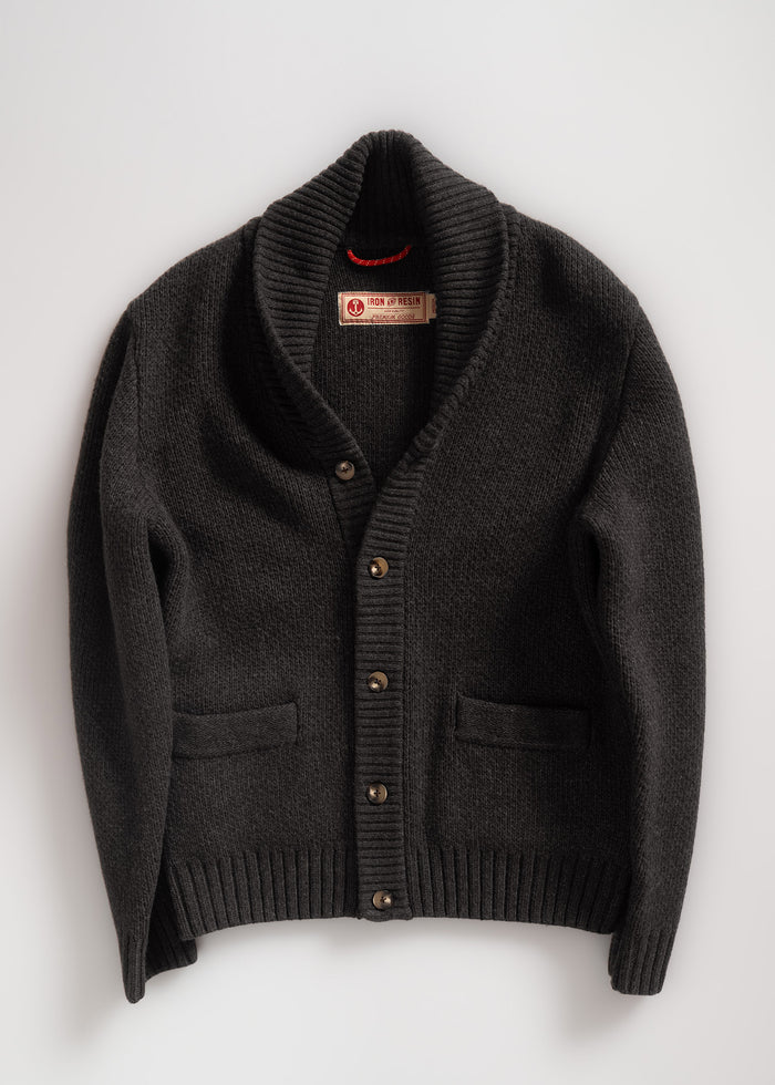 Dark shawl collar cardigan with buttons and pockets, labeled Iron & Resin, displayed on a white background. Cozy and stylish.