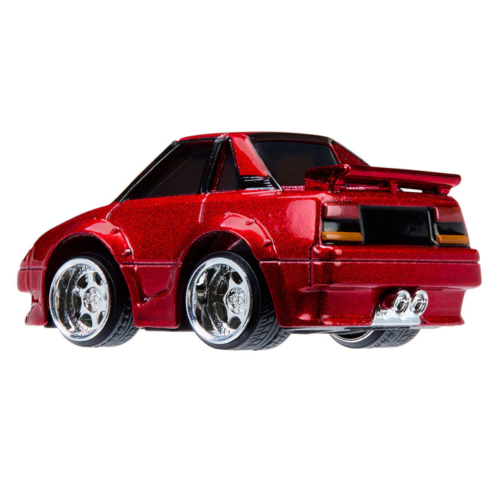 Red toy car with chrome wheels on a white background