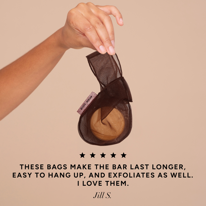 Hand holding the Kitsch Chocolate Body Wash Bar Bag with a 5-star customer review quote: "These bags make the bar last longer, easy to hang up, and exfoliates as well. I love them." – Jill S.