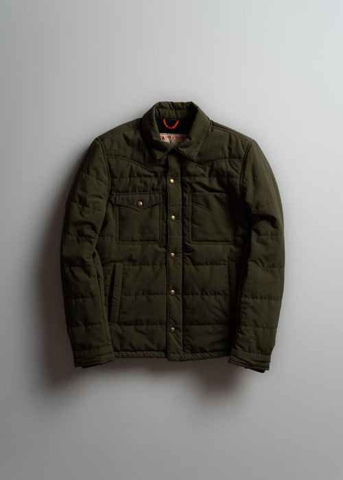 Olive green quilted jacket with button closure and two chest pockets, displayed against a plain background.