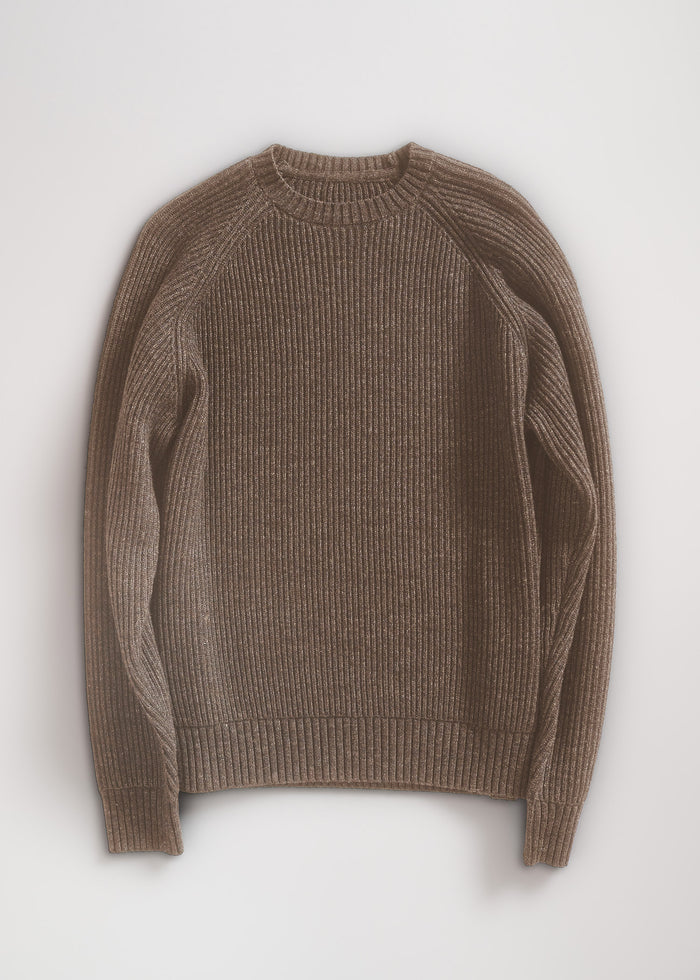Brown ribbed sweater with long sleeves, laid flat on a light background, showcasing its texture and simple design.