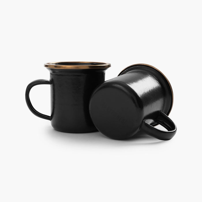 Two 5 oz black enamel espresso cups with copper plated rims on a white background.