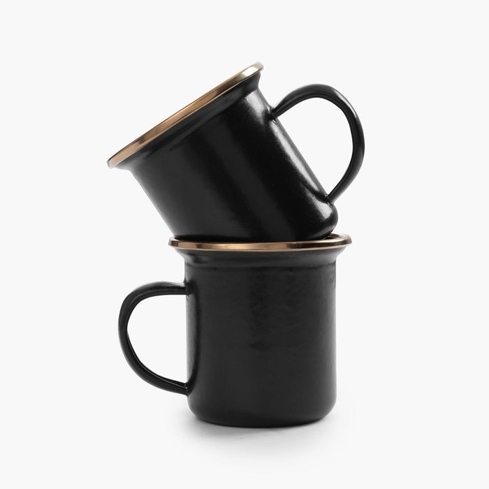 Two stacked 5 oz black enamel espresso cups with copper plated rims on a white background.