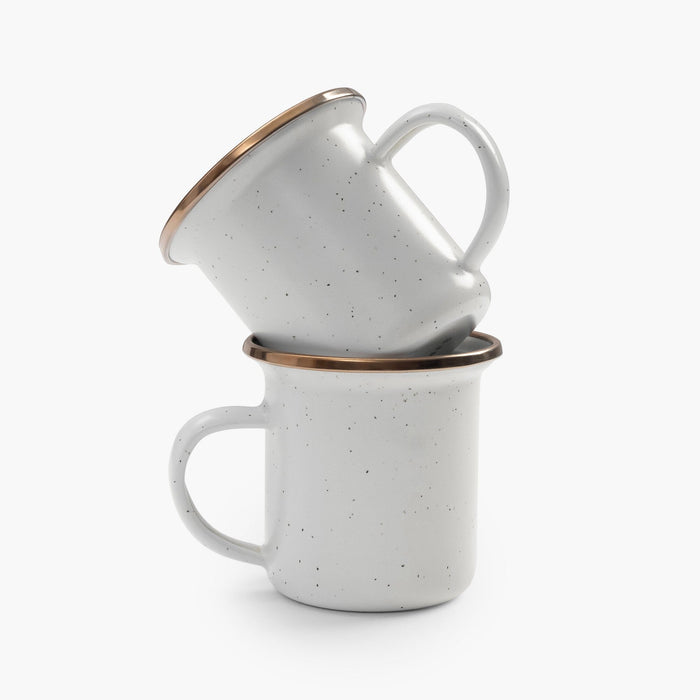 Two stacked 5 oz speckled eggshell enamel espresso cups with copper plated rims on a white background.