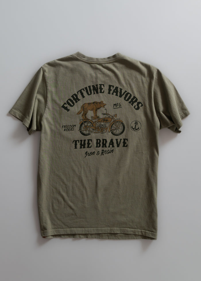 Olive t-shirt with "Fortune Favors the Brave" text, wolf on motorcycle graphic, and "Iron & Resin" branding on the back.