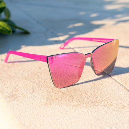 still life - diff eyewear featuring the goldie cat eye sunglasses with a bright tulip frame and pink rush mirror lenses
