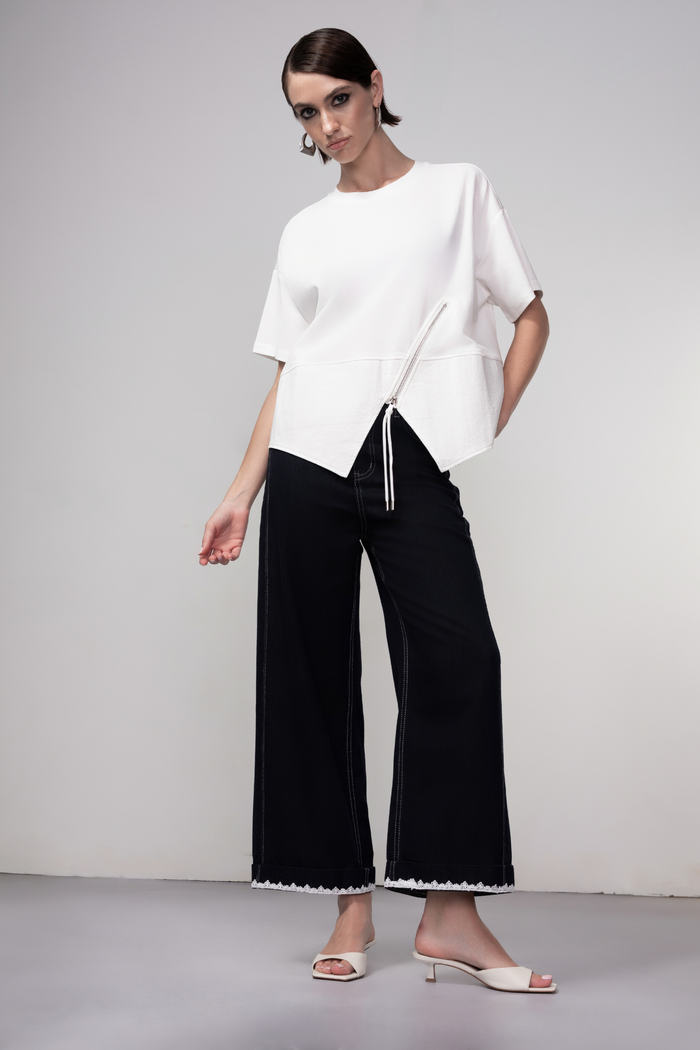 Haako dark blue wide leg jeans with contrast stitching and cream belt, styled for a modern minimalist look
