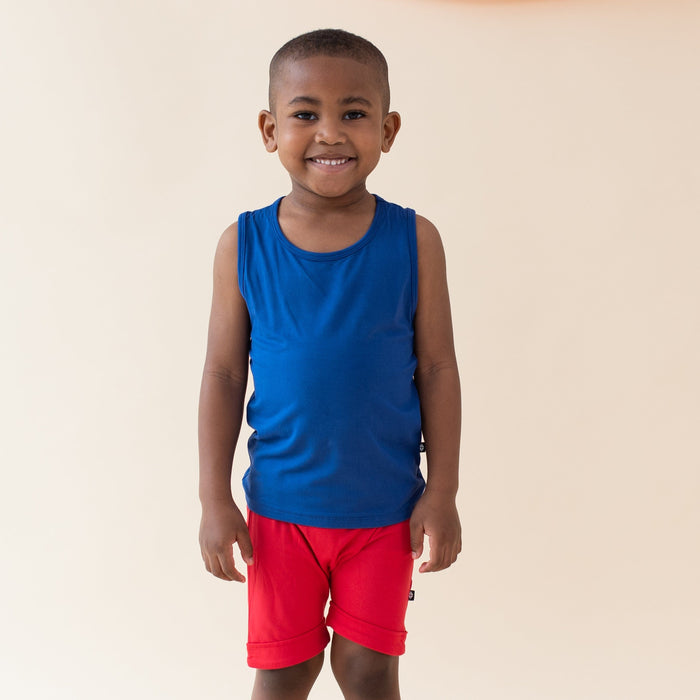 Boy wearing Kyte Baby Harem Shorts in Cardinal