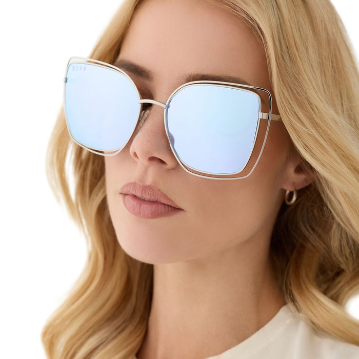 on model - female wearing diff eyewear featuring the jacqueline square sunglasses with a silver thistle temple tips frame and lavender mirror lenses angled view