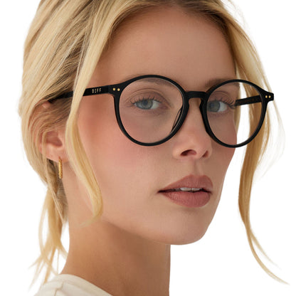 on model - blonde female wearing diff eyewear joanie round glasses with a black acetate frame angled view