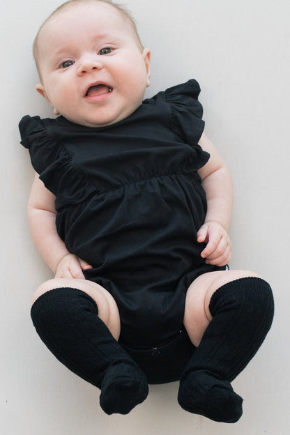 Infant wearing Kyte Baby cable knit Knee High Socks in Midnight