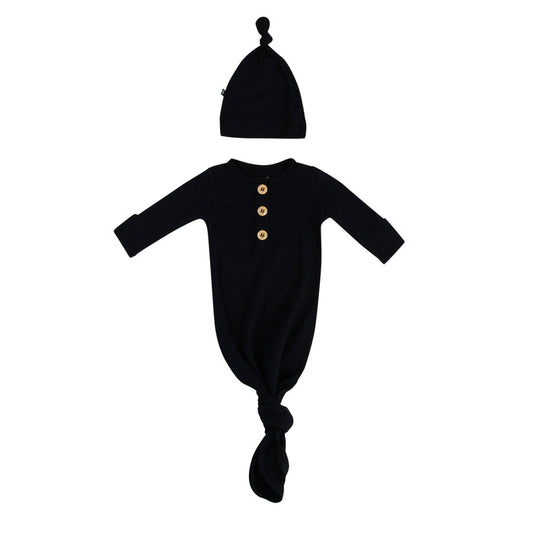 Flat lay of Kyte Baby Knotted Gown with Hat Set in Midnight