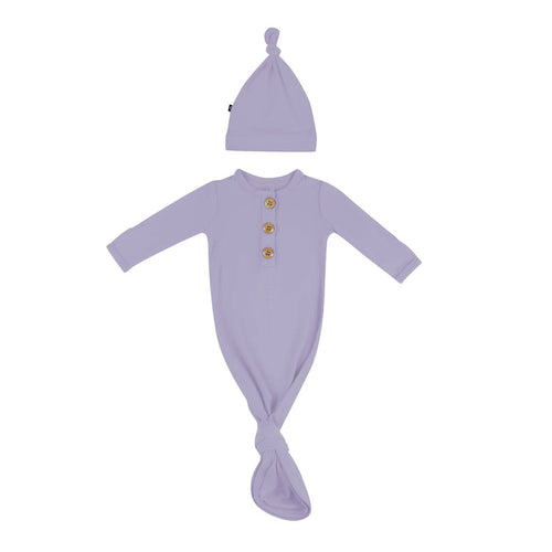 Flat lay of Kyte Baby Knotted Gown with Hat Set in Taro