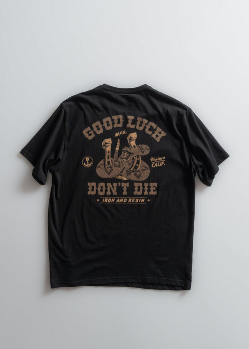 Black t-shirt with "Good Luck Don't Die" and snake design in brown. Text includes "Iron and Resin" and "Ventura Calif."