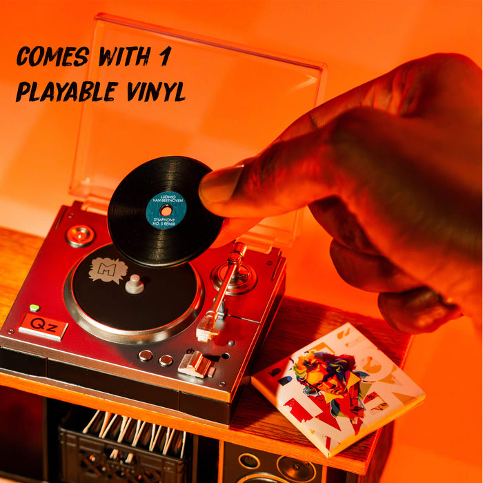Person placing a vinyl record on a turntable with text indicating one playable vinyl included.