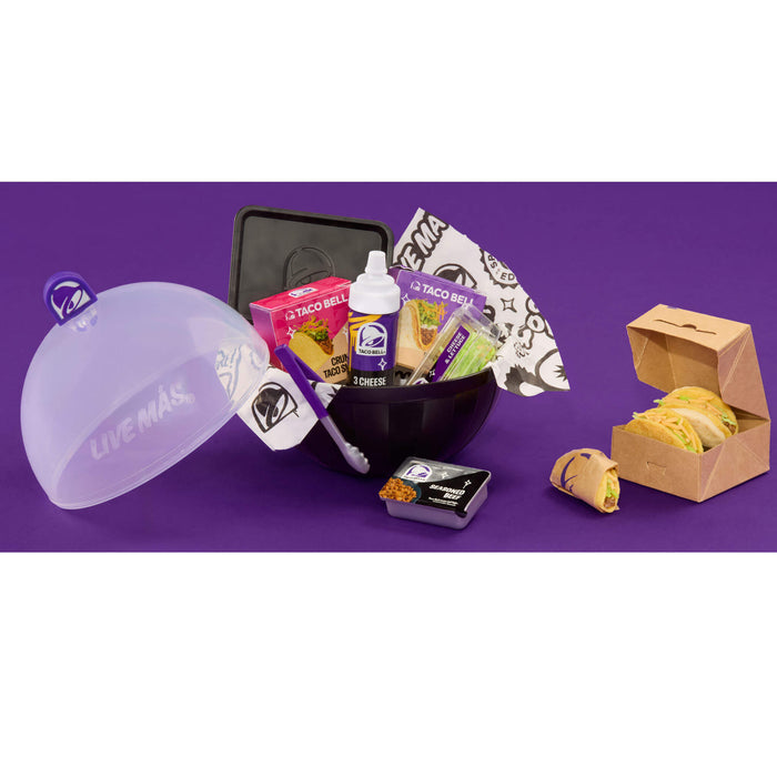 Collection of Taco Bell products including a bowl, and packaging on a purple background