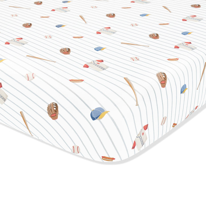 Corner of the Mini Crib Sheet in Home Run shown on a crib mattress