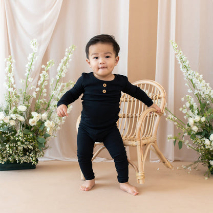 Toddler wearing Kyte Baby bamboo Ribbed Henley Set in Midnight black