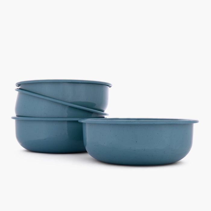 Set of four smoky blue rolled enamel bowls on a white background