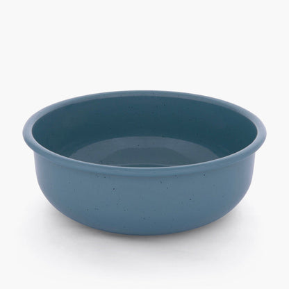A smoky blue rolled enamel bowl on a white background