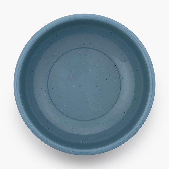 A smoky blue rolled enamel bowl on a white background