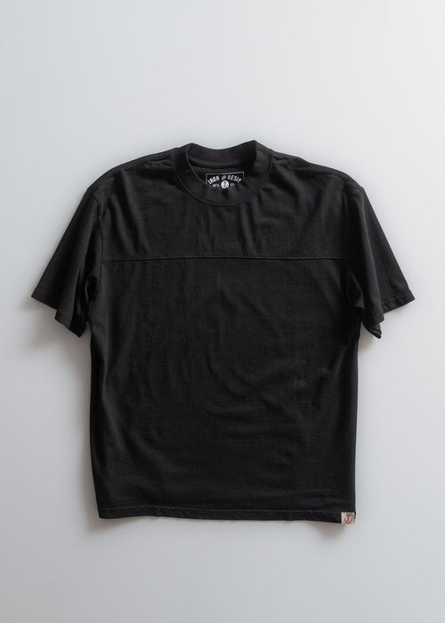 Black short-sleeve T-shirt with a round neck and subtle stitching, displayed flat on a light background.