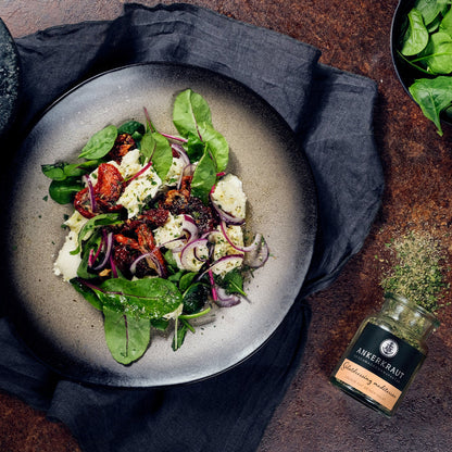 Frischer Salat mit getrockneten Tomaten, roten Zwiebeln, Feta und mediterranem Salatdressing von Ankerkraut.