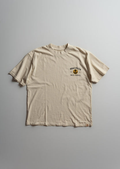Beige T-shirt with "Iron & Resin Sales & Service" logo on chest, laid flat on a light gray background.