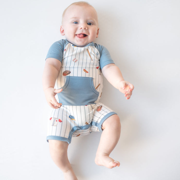 Smiling infant waring the Shortall in Home Run