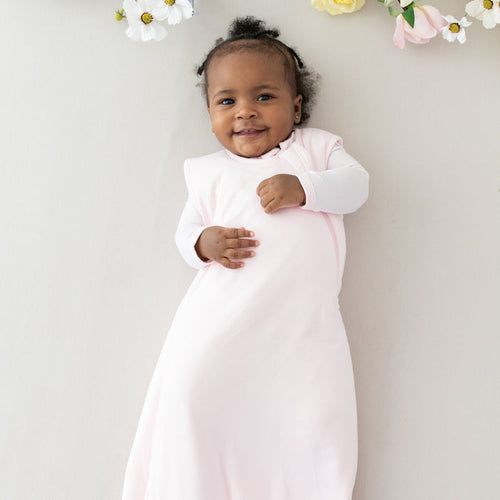 Infant wearing Kyte Baby Sleep Bag in Sakura 1.0