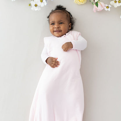 Baby wearing Kyte Baby bamboo Sleep Bag TOG 1.0 in Sakura pink