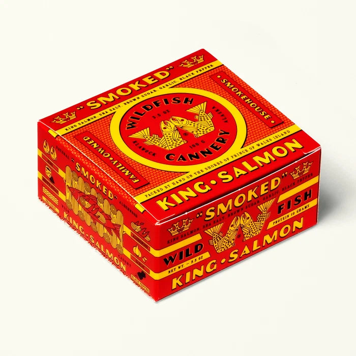 Red and yellow box of smoked salmon from Wildfish Cannery on a white background