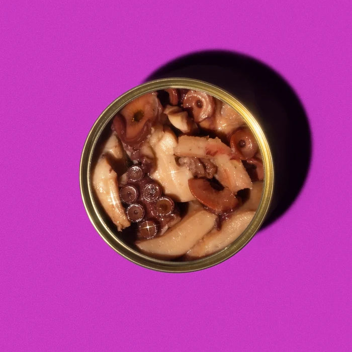Canned food with mushrooms and chocolate pieces on a purple background