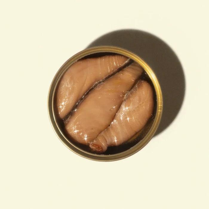 Can of pickled herring on a beige background