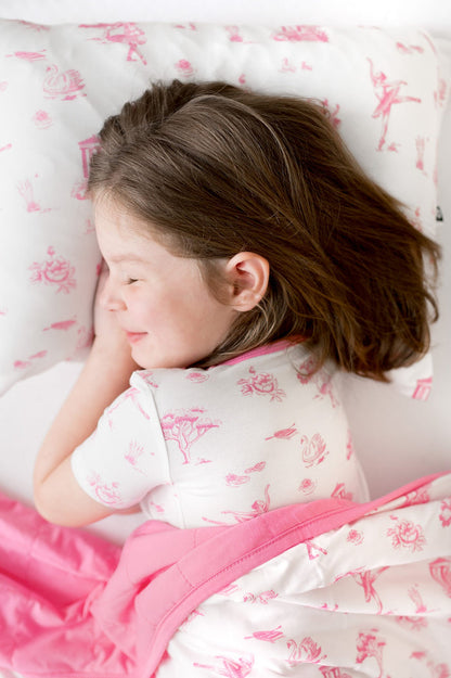 Young girl laying on a Standard Pillowcase in Toile Ballet
