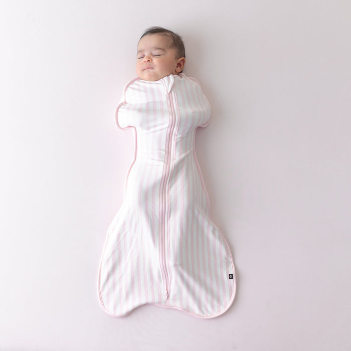 Sleeping newborn wearing the soft and stretchy Swaddle Bag in Small Sakura Stripe 0.5