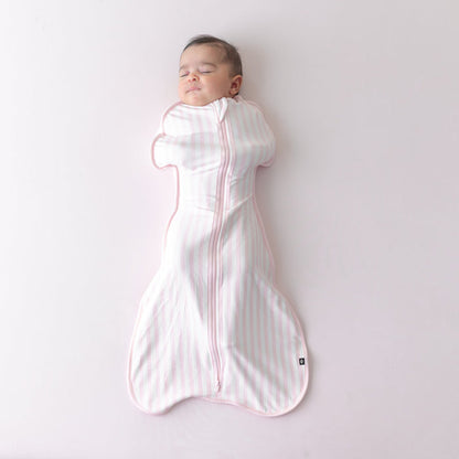 Sleeping newborn wearing the soft and stretchy Swaddle Bag in Small Sakura Stripe 0.5