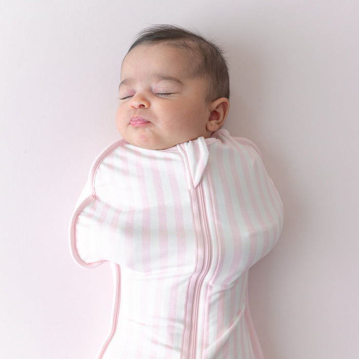 Close up of sleeping newborn wearing the Swaddle Bag in Small Sakura Stripe 0.5