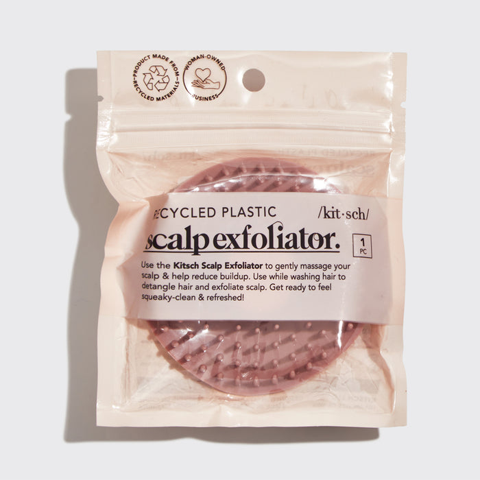 Model using Terracotta Scalp Exfoliator on scalp while shampooing showing circular massage motion