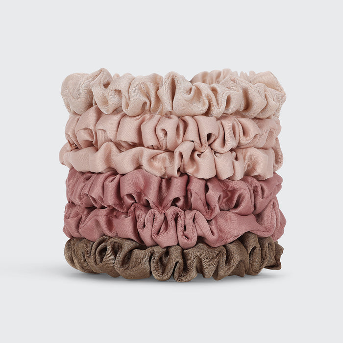 Six Ultra Petite Satin Scrunchies stacked in neutral terracotta, blush, and brown shades