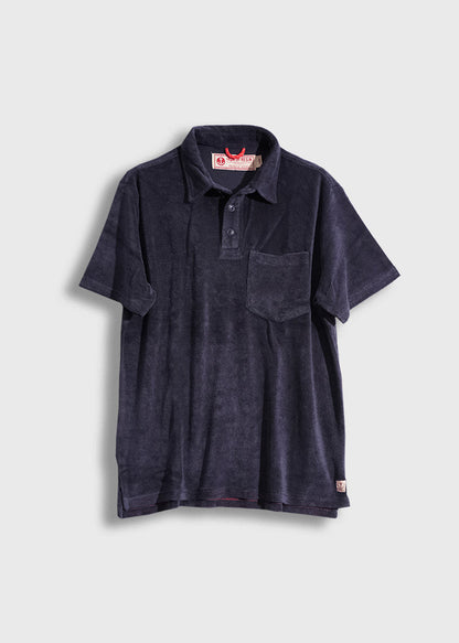 Navy blue terry cloth polo shirt with a pocket, buttoned collar, and red label, displayed against a plain background.