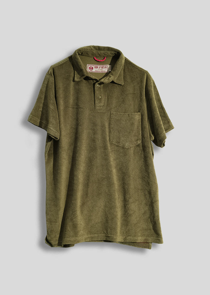 Olive green terry cloth polo shirt with a chest pocket, displayed against a plain background, showcasing casual style.