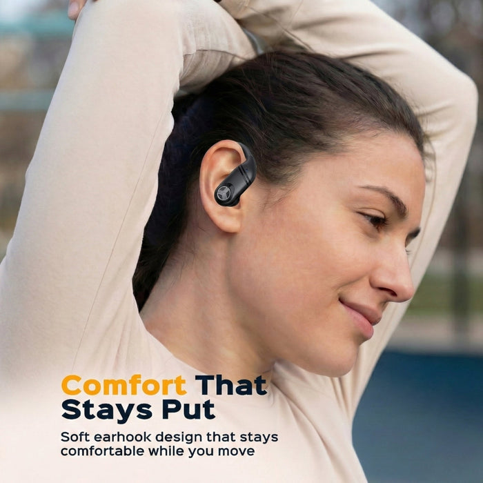 Woman wearing a wireless earbud with text 'Comfort That Stays Put' on a blurred outdoor background